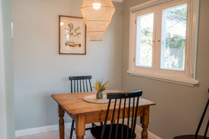 Dining area with wooden table and chairs near a window