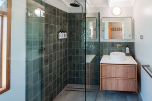 Modern bathroom with shower, sink, and vanity area.
